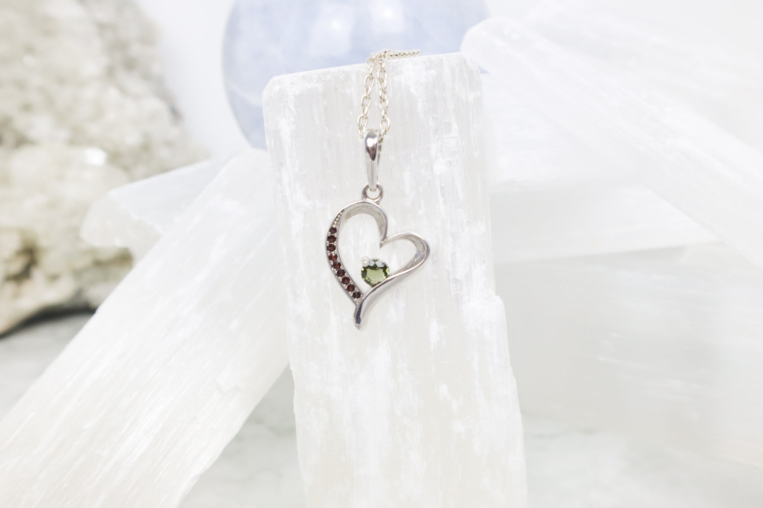 Moldavite heart pendant with garnet crystals